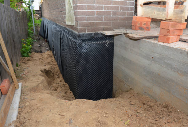 Happy homeowners after waterproofing job in Lamont